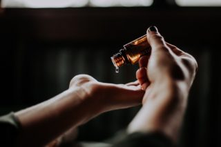 pouring essential oil into hand