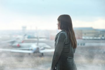 woman looking at airplanes at airport